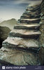 Ancient worn stone steps going up and mountains in the ___.jpg